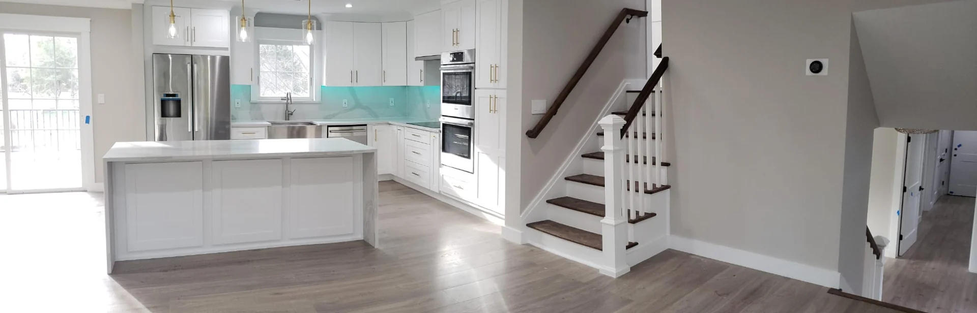 White island kitchen beside a split-level staircase from the Innova project archive